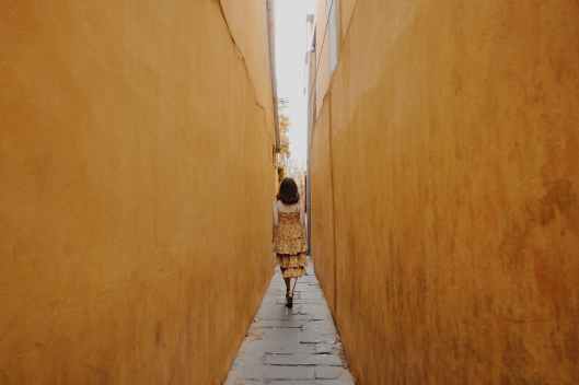 photo of woman walk through pathway